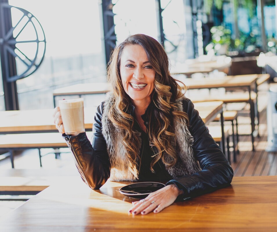 nz female entrepreneur drinking coffee in cafe