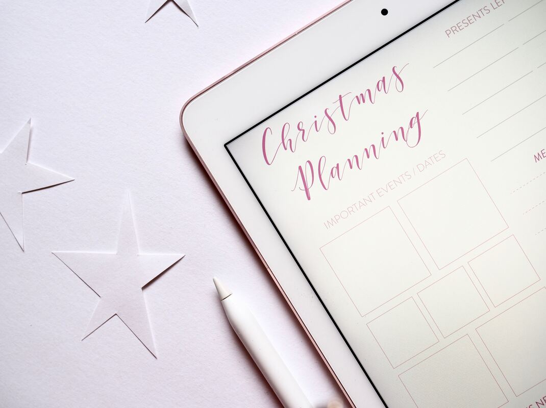 Christmas planning template on an iPad with paper stars